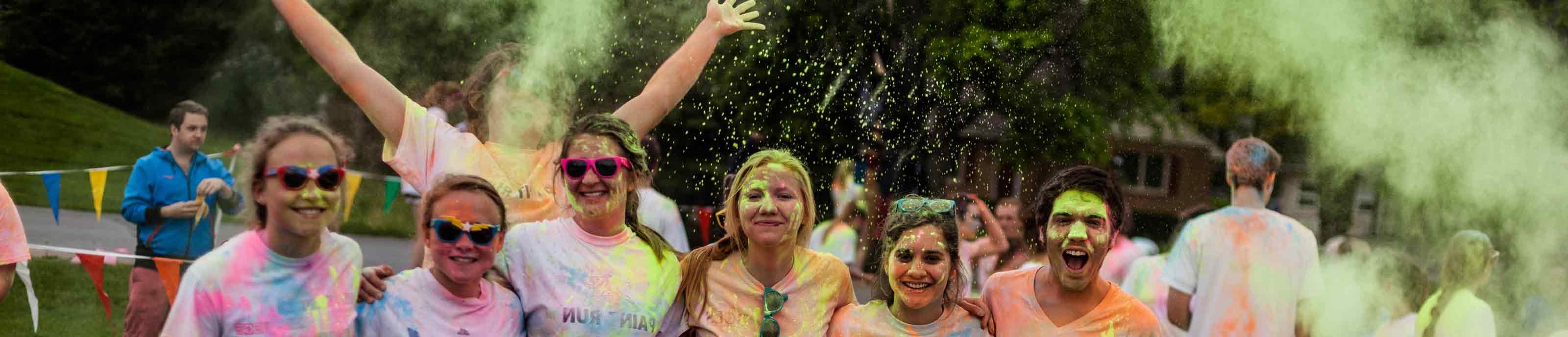 Students having fun in clouds of brightly-colored powder at the Color Run